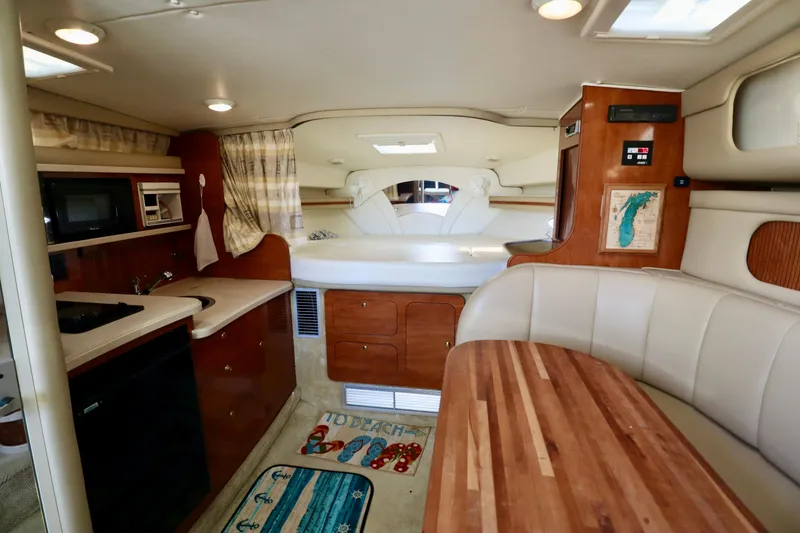 Slide: The Image of Interior of 2002 Rinker 342 Fiesta Vee boat with kitchenette, seating, and sleeping area. - 4