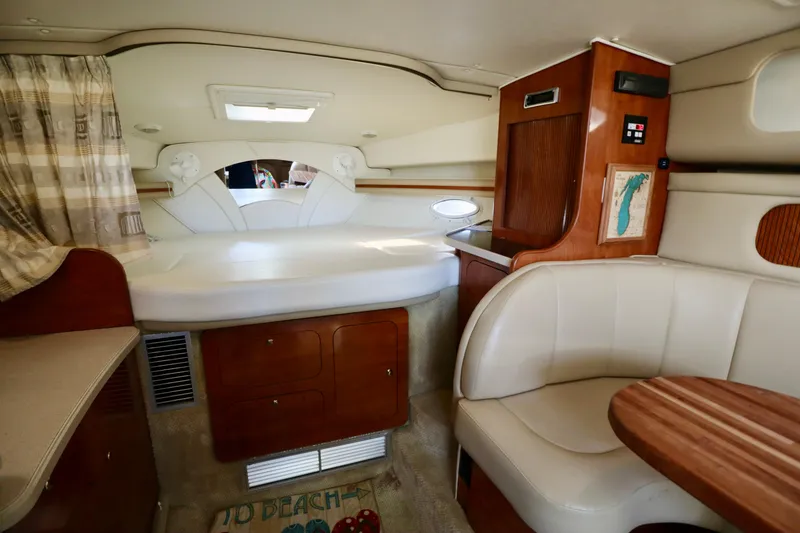 Slide: The Image of Interior cabin of a 2002 Rinker 342 Fiesta Vee boat with bed and seating area. - 6
