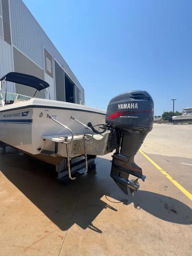 Slide: The Image of 1989 Grady-White Seafarer 226 with Yamaha outboard motor in a marina. - 4