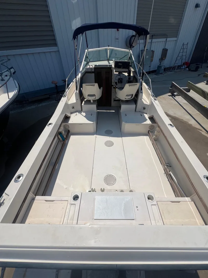 Slide: The Image of 1989 Grady-White Seafarer 226 boat with open deck and canopy. - 5