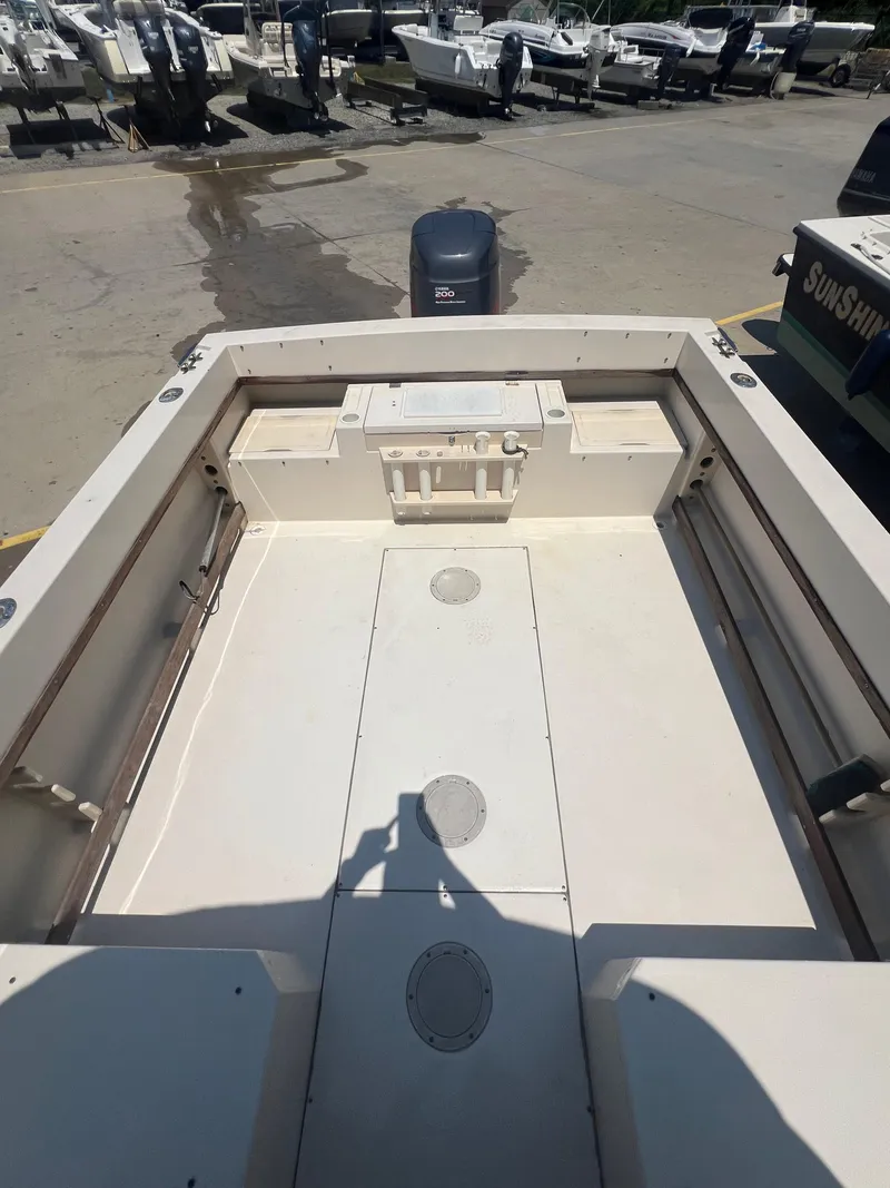 Slide: The Image of 1989 Grady-White Seafarer 226 boat deck with storage compartments and outboard motor. - 6