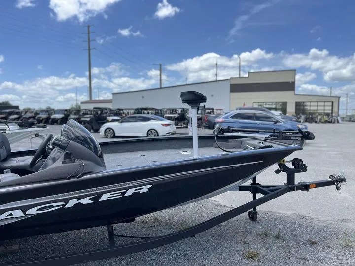 Slide: The Image of 2024 Tracker Pro Team 175 TF boat on a trailer in a parking lot. - 11