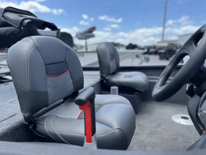 Slide: The Image of 2024 Tracker Pro Team 175 TF boat interior with gray seats and steering wheel. - 14