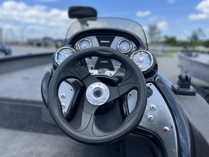 Slide: The Image of 2024 Tracker Pro Team 175 TF boat dashboard with steering wheel and gauges. - 15