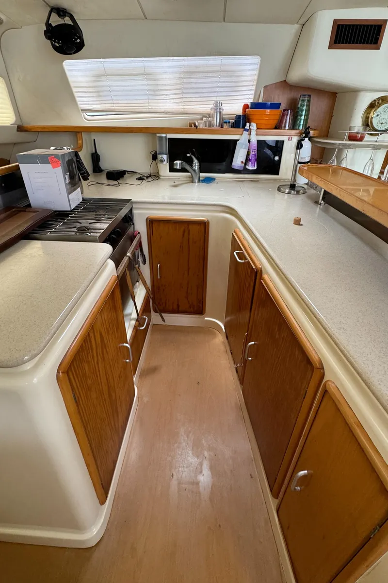 Slide: The Image of 2003 Leopard 47 yacht kitchen with wooden cabinets and modern appliances. - 11