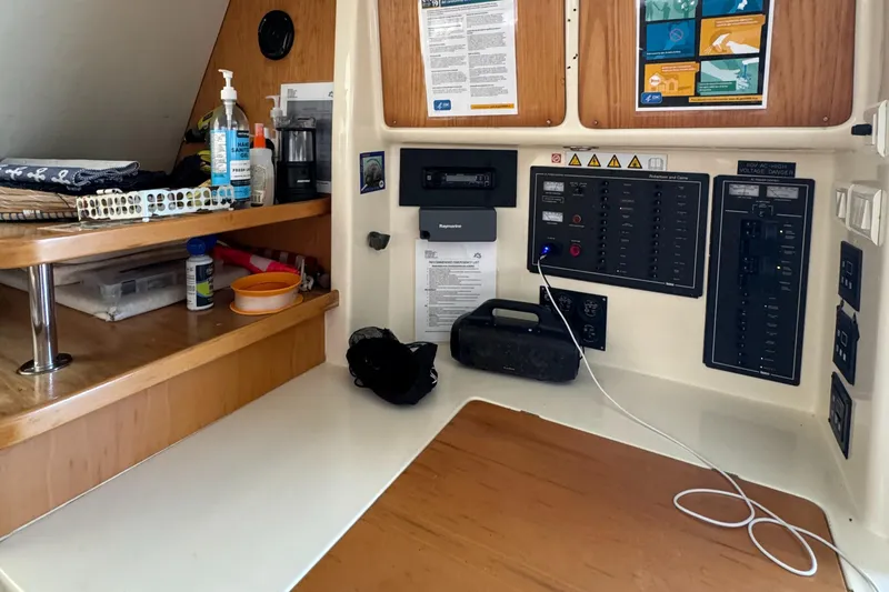 Slide: The Image of Navigation station on a 2003 Leopard 47 catamaran with control panels and storage. - 14