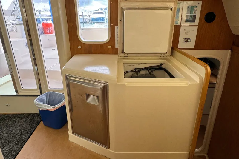 Slide: The Image of Interior of 2003 Leopard 47 yacht with washing machine and storage area. - 15