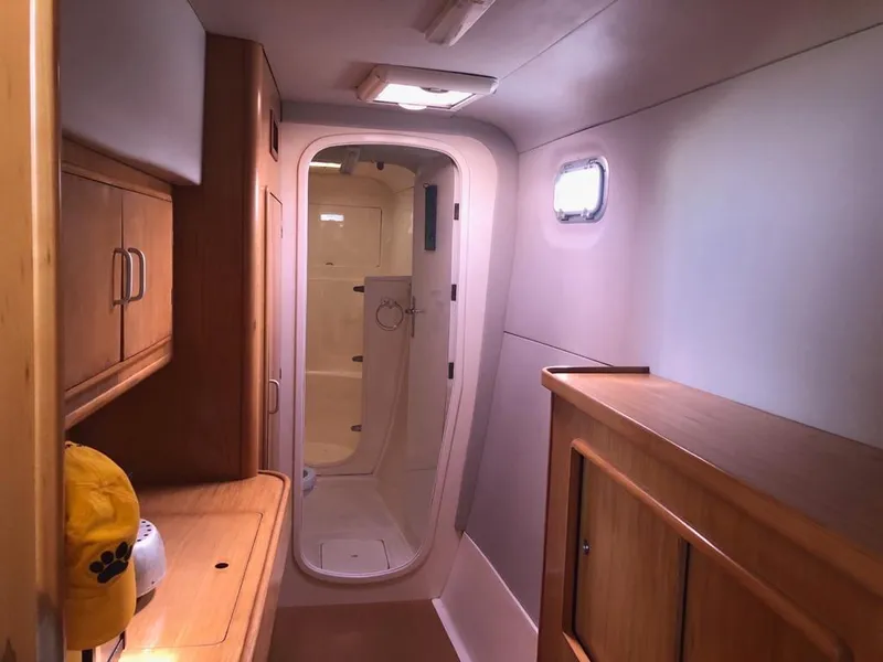 Slide: The Image of Interior of 2003 Leopard 47 yacht with wooden cabinetry and compact bathroom. - 16