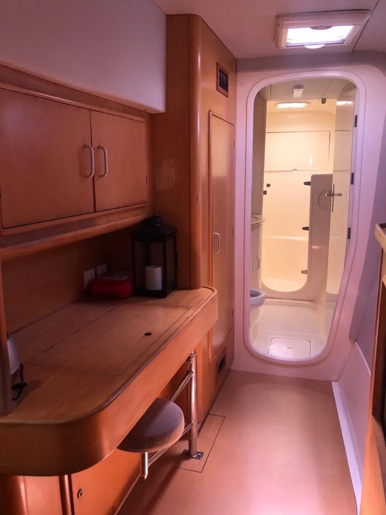 Slide: The Image of Interior of 2003 Leopard 47 yacht with wooden cabinetry and modern bathroom. - 19