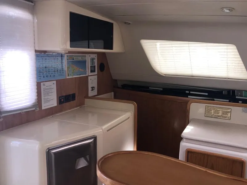 Slide: The Image of Interior of 2003 Leopard 47 yacht with modern kitchen and wooden accents. - 20