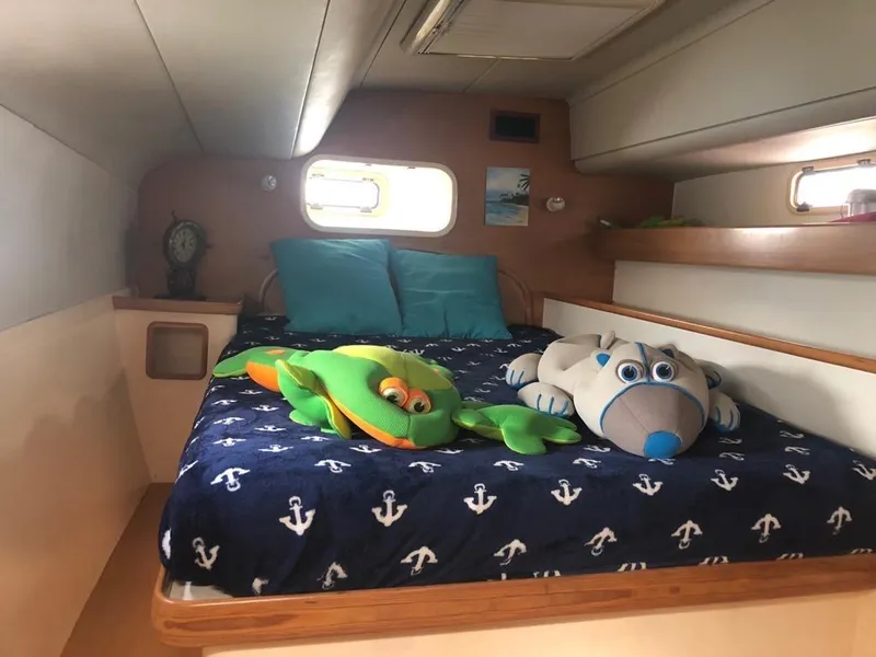 Slide: The Image of Cozy cabin bedroom in 2003 Leopard 47 yacht with plush toys and nautical bedding. - 21