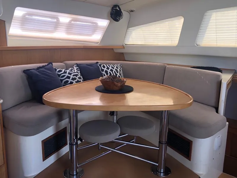 Slide: The Image of Cozy dining area in 2003 Leopard 47 yacht with cushioned seating and decorative pillows. - 23