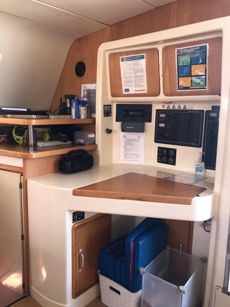 Slide: The Image of 2003 Leopard 47 yacht interior navigation station with control panels and storage. - 24