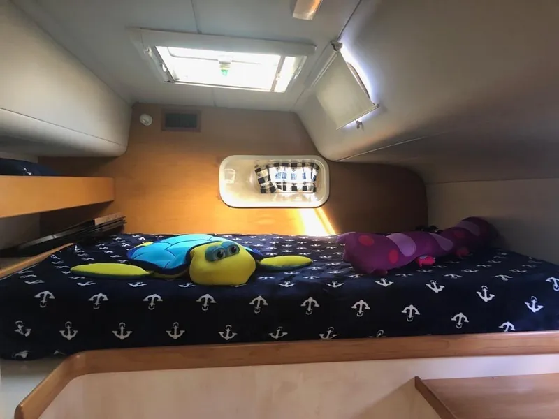 Slide: The Image of Cozy cabin interior of 2003 Leopard 47 yacht with plush toys and nautical bedding. - 25
