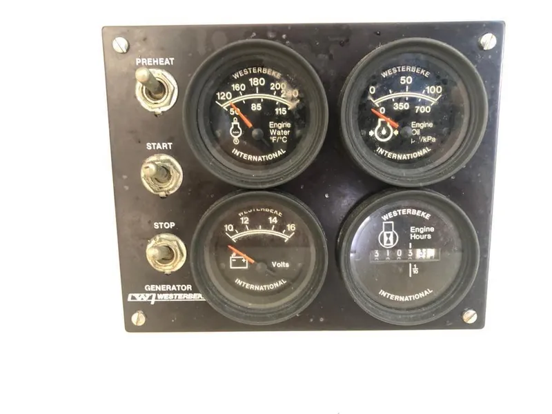 Slide: The Image of Westerbeke generator control panel with gauges and switches, Leopard 47, 2003 model. - 28