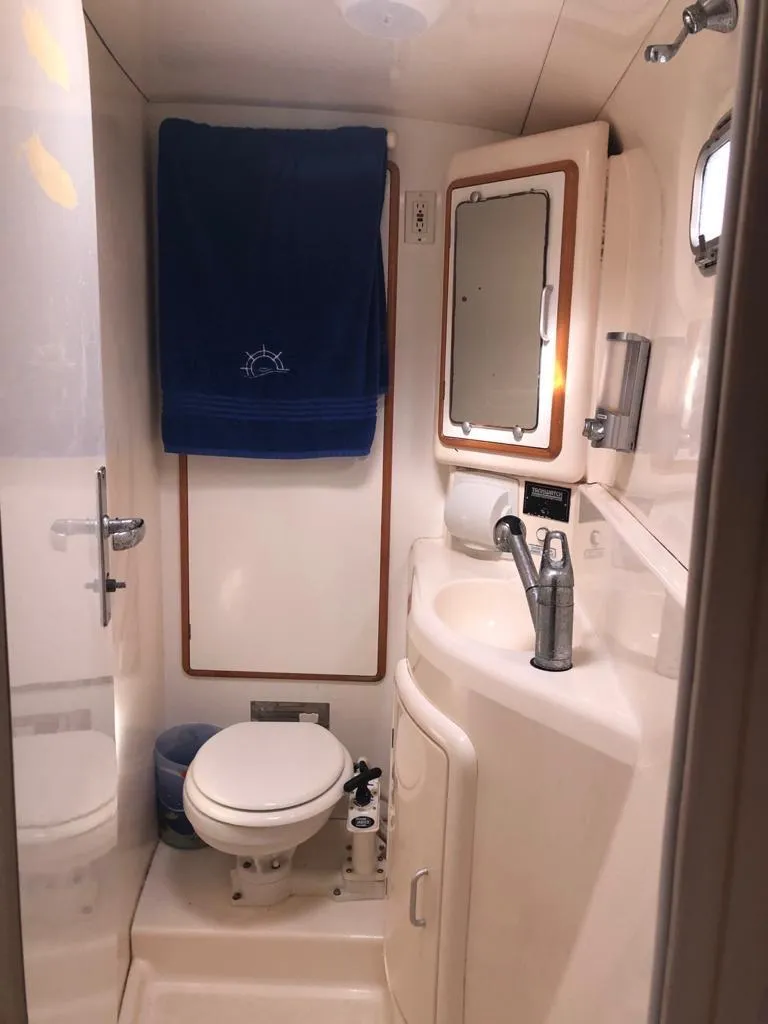 Slide: The Image of Compact bathroom in 2003 Leopard 47 yacht with sink, toilet, and mirror. - 30