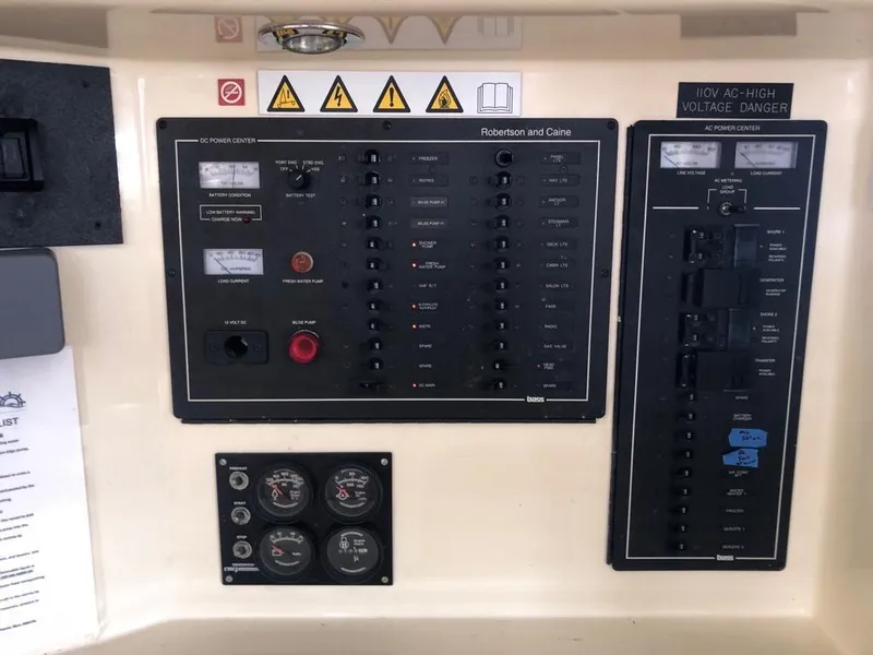 Slide: The Image of Electrical control panel on a 2003 Leopard 47 yacht with warning labels and gauges. - 31