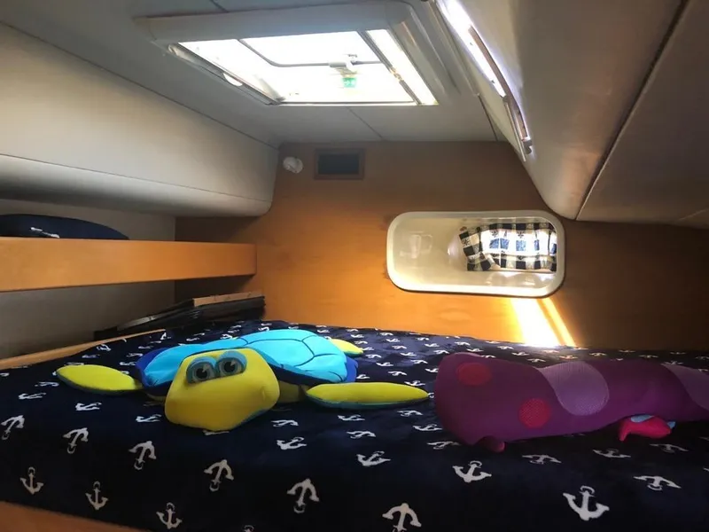 Slide: The Image of Cozy cabin interior of 2003 Leopard 47 yacht with plush toys on bed. - 32