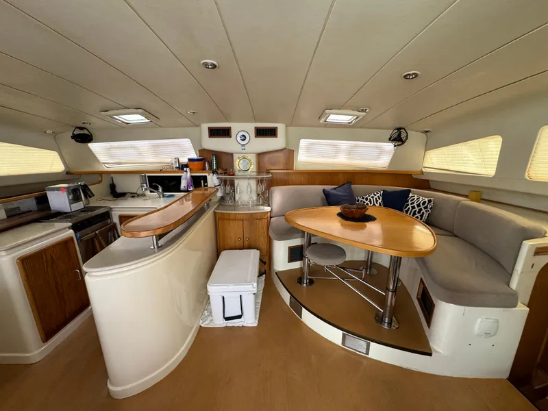 Slide: The Image of Spacious interior of 2003 Leopard 47 yacht with modern kitchen and dining area. - 7