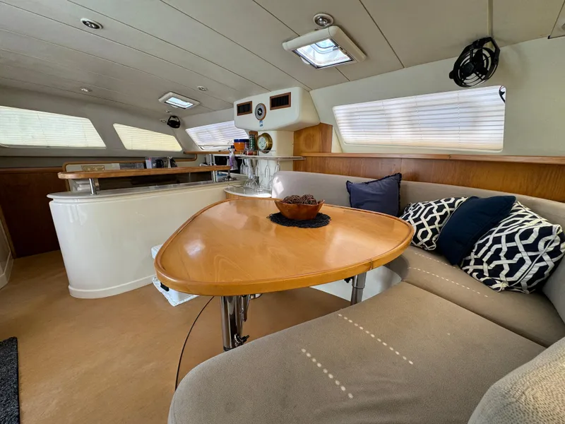 Slide: The Image of Spacious interior of 2003 Leopard 47 yacht with modern dining area and cozy seating. - 8