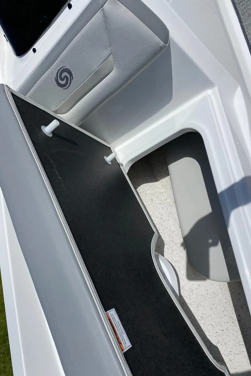 Slide: The Image of 2022 Hurricane SS 205 boat interior storage compartment with cushioned seating. - 11