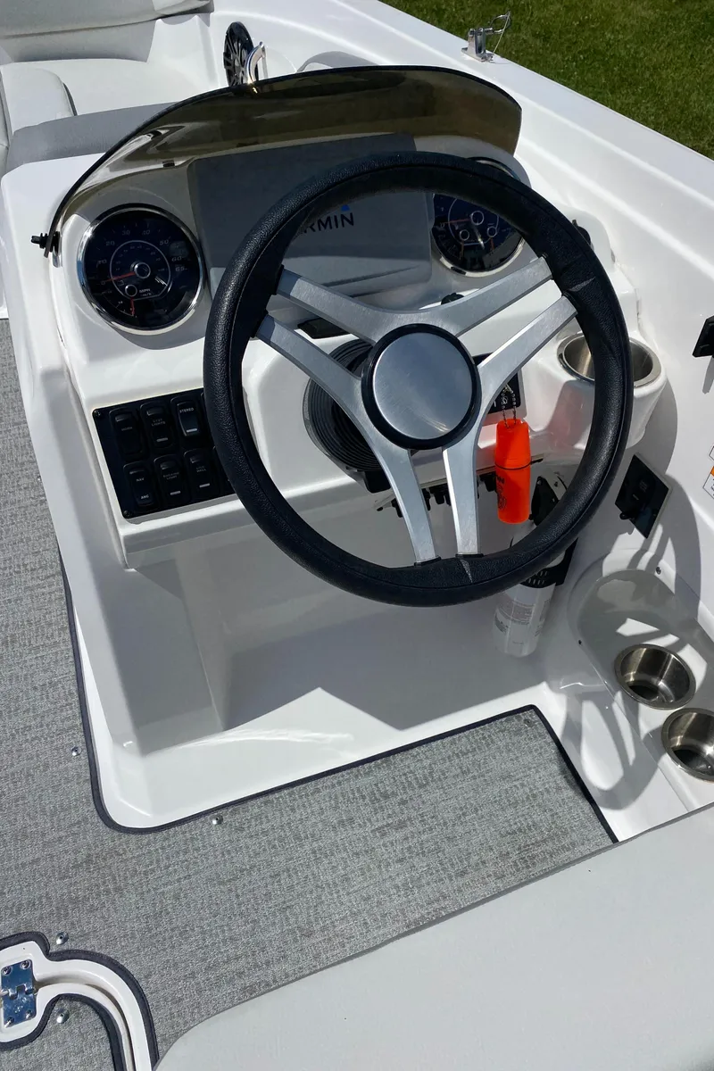 Slide: The Image of 2022 Hurricane SS 205 boat dashboard with steering wheel and instrument panel. - 14