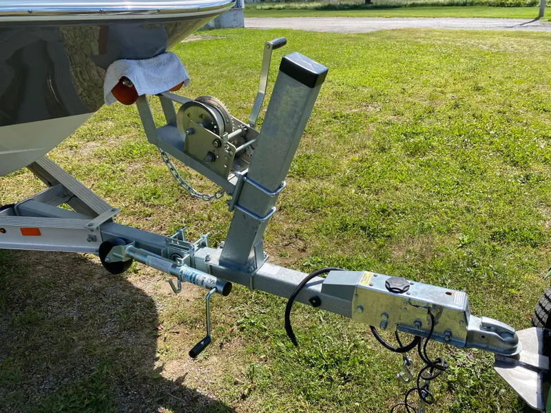 Slide: The Image of Trailer hitch of a 2022 Hurricane SS 205 boat on grass. - 18
