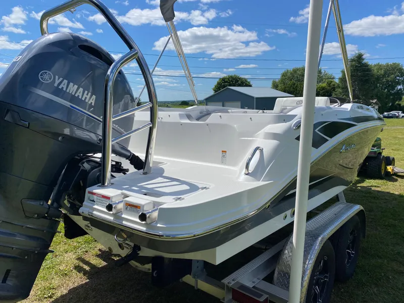 Slide: The Image of 2022 Hurricane SS 205 boat with Yamaha engine on trailer, outdoors under blue sky. - 2