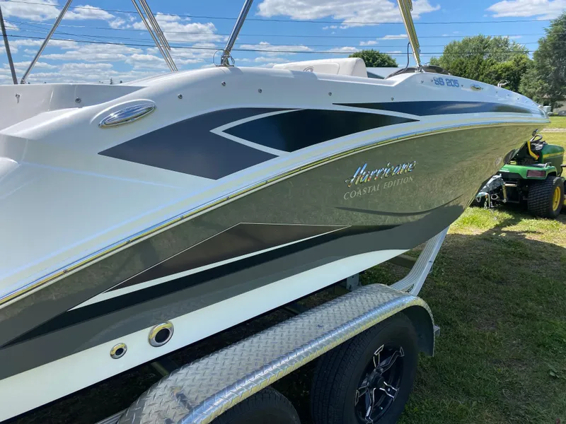Slide: The Image of 2022 Hurricane SS 205 boat on trailer, sleek design, white and black accents, outdoor setting. - 3