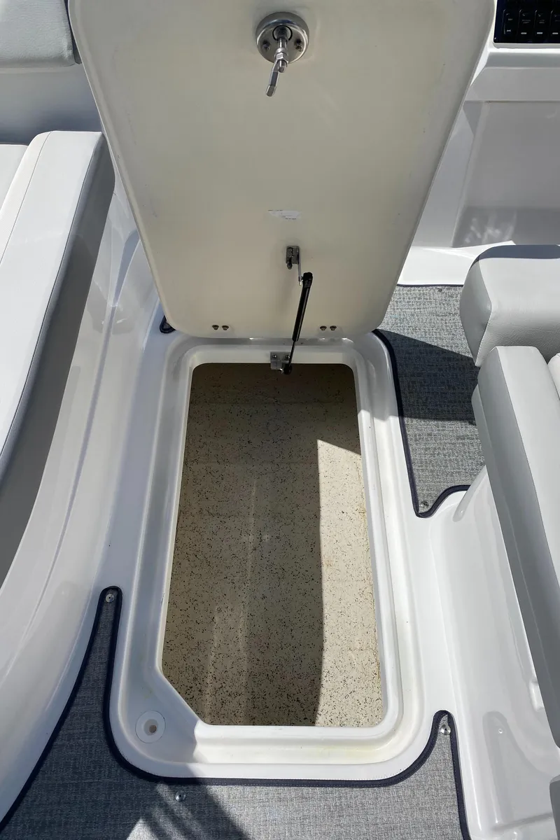 Slide: The Image of 2022 Hurricane SS 205 boat storage compartment with open hatch, showcasing interior space. - 8
