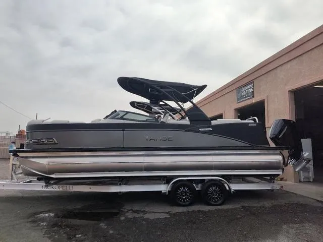 Slide: The Image of 2024 Tahoe Cascade Quad Lounge Windshield 25 FT pontoon boat on trailer. - 1