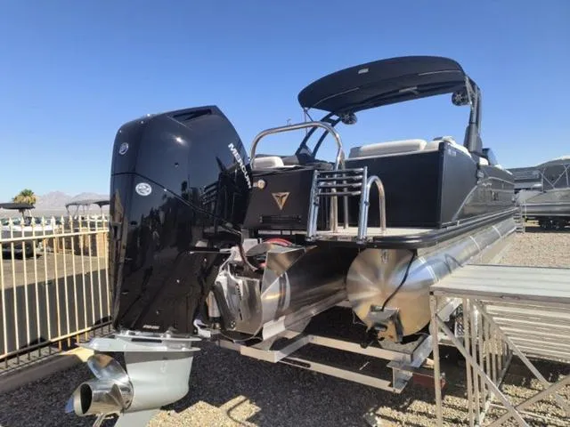 Slide: The Image of 2024 Tahoe Cascade Quad Lounge Windshield 25 FT pontoon boat in a dock. - 10