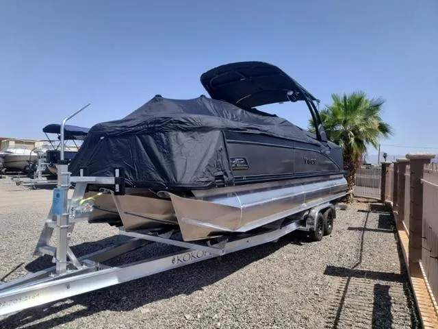 Slide: The Image of 2024 Tahoe Cascade Quad Lounge Windshield 25 FT pontoon boat with Mercury outboard engine. - 12