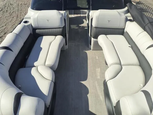 Slide: The Image of 2024 Tahoe Cascade Quad Lounge Windshield 25 FT pontoon boat interior with spacious seating. - 16