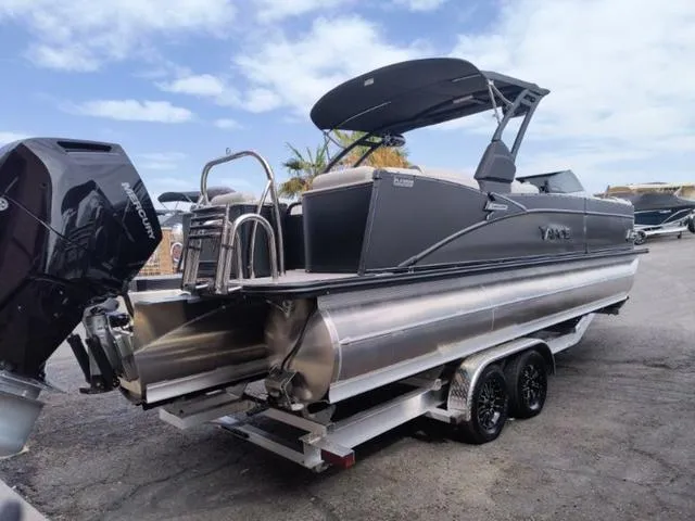 Slide: The Image of 2024 Tahoe Cascade Quad Lounge Windshield 25 FT pontoon boat on trailer. - 2