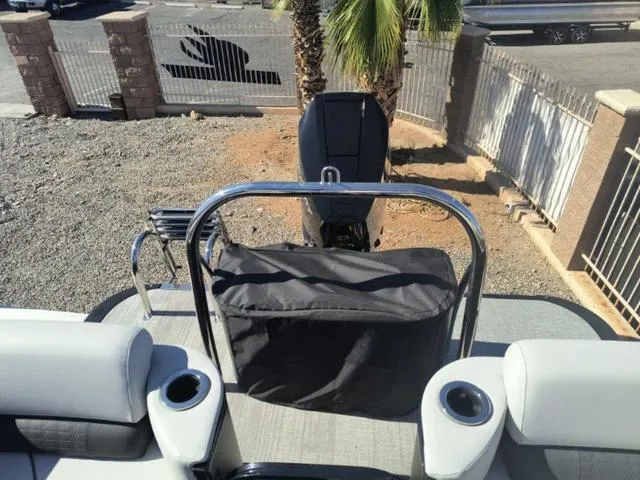 Slide: The Image of 2024 Tahoe Cascade Quad Lounge Windshield 25 FT boat interior with seating and cup holders. - 20