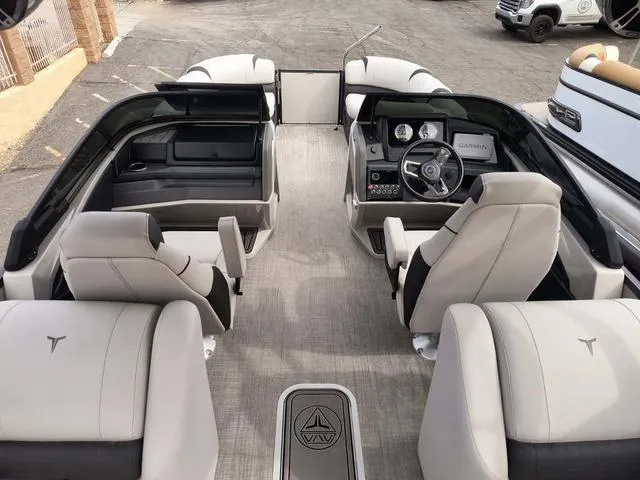 Slide: The Image of 2024 Tahoe Cascade Quad Lounge Windshield 25 FT interior with modern seating and steering console. - 22