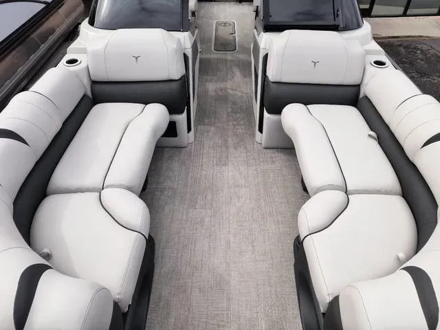 Slide: The Image of 2024 Tahoe Cascade Quad Lounge Windshield 25 FT interior with plush seating and modern design. - 29
