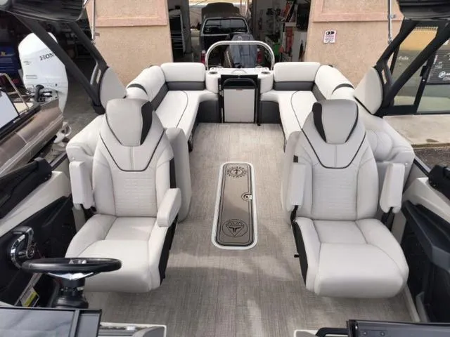 Slide: The Image of 2024 Tahoe Cascade Quad Lounge Windshield 25 FT boat interior with luxurious seating. - 31
