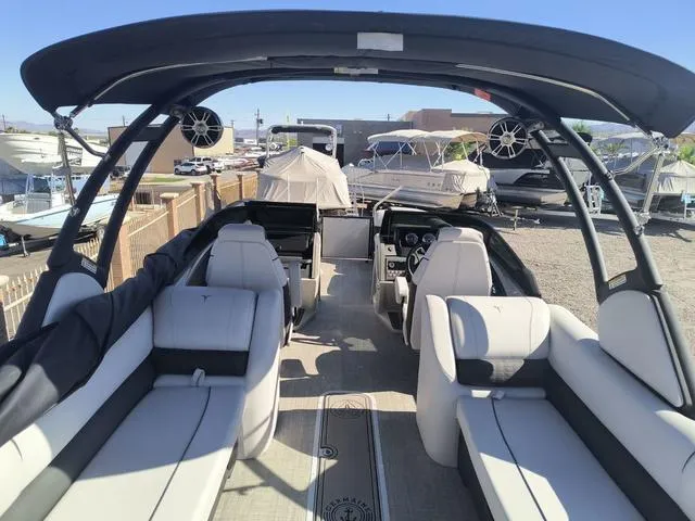Slide: The Image of 2024 Tahoe Cascade Quad Lounge Windshield 25 FT boat on trailer at Germaine Marine. - 6