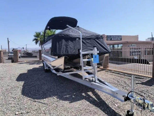 Slide: The Image of 2024 Tahoe Cascade Quad Lounge Windshield 25 FT pontoon boat on trailer. - 9