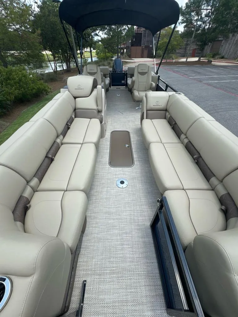Slide: The Image of 2024 Regency 250 LE3 pontoon boat with spacious seating and canopy. - 4