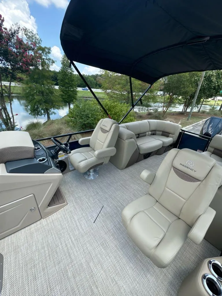 Slide: The Image of 2024 Regency 250 LE3 pontoon boat interior with luxurious seating and canopy. - 5