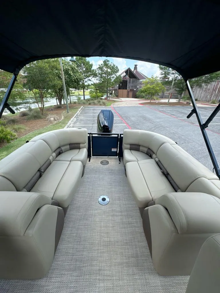 Slide: The Image of 2024 Regency 250 LE3 pontoon boat with spacious seating and canopy. - 6