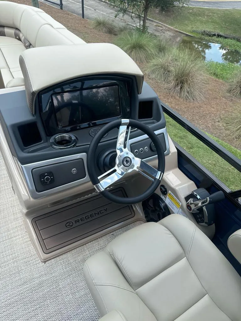 Slide: The Image of 2024 Regency 250 LE3 boat helm with modern controls and comfortable seating. - 7