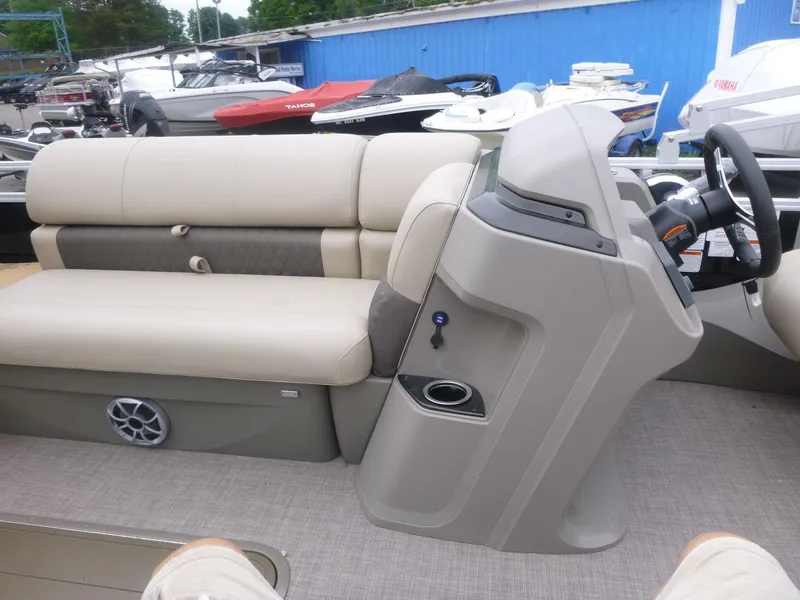 Slide: The Image of 2024 Sun Tracker Sportfish 24 XP3 interior with beige seating and steering console. - 10