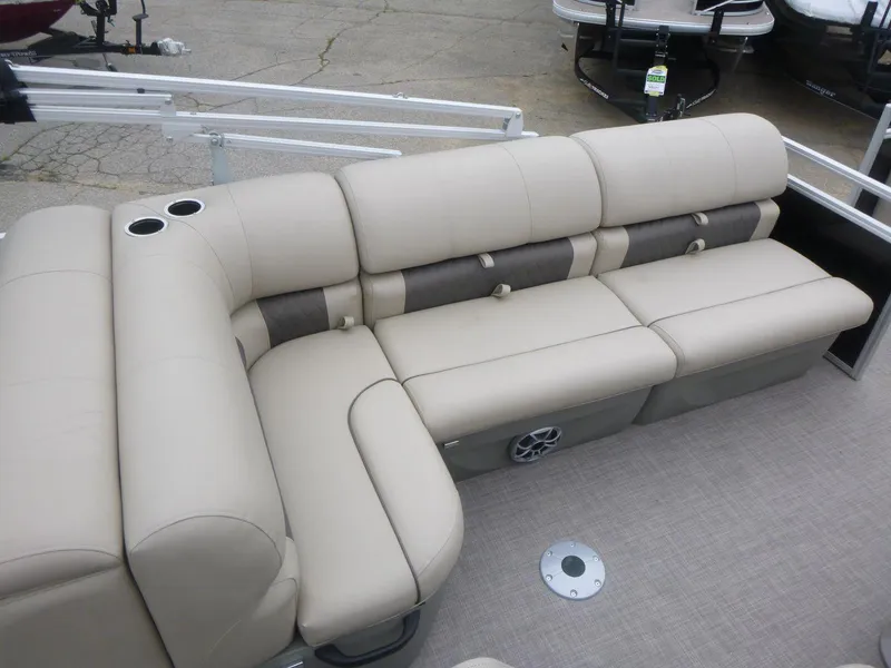 Slide: The Image of 2024 Sun Tracker Sportfish 24 XP3 boat with beige seating and cup holders. - 12