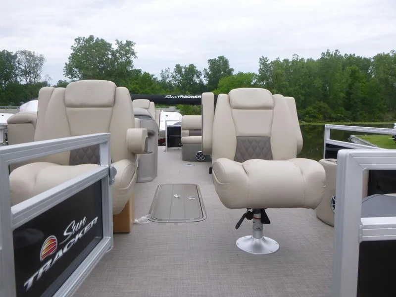 Slide: The Image of 2024 Sun Tracker Sportfish 24 XP3 pontoon boat with beige seating and spacious deck. - 8