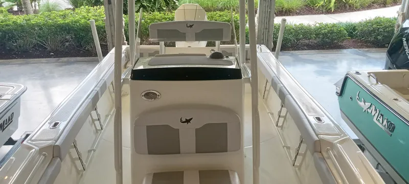 Slide: The Image of 2024 Mako 214 CC boat interior with center console and seating. - 2