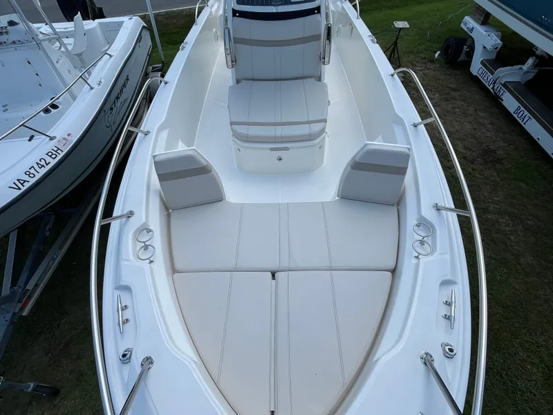 Slide: The Image of 2024 Boston Whaler 250 Dauntless boat interior with cushioned seating and stainless steel railings. - 18